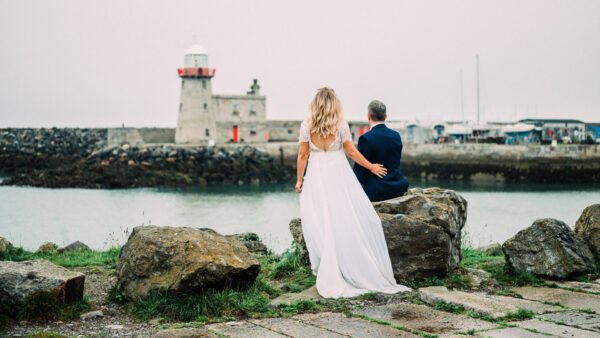 Wedding couple looking out to the Howth lighthouse